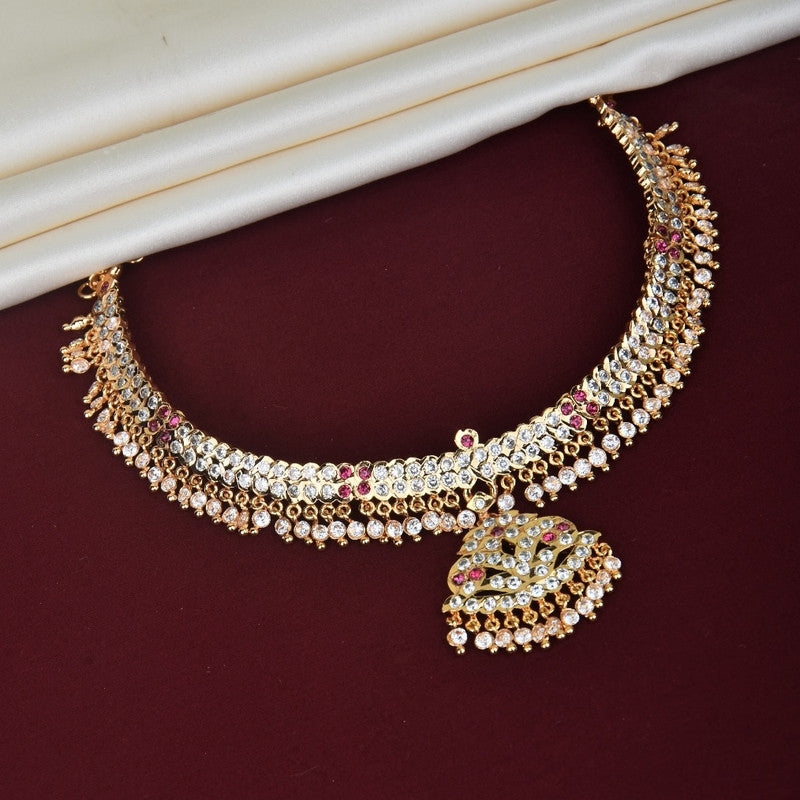 A gold and silver choker necklace with red and white gemstones, featuring a large pendant adorned with intricate designs and dangling beads.