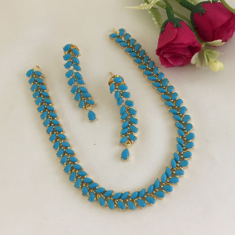 A turquoise and gold necklace with matching earrings, featuring a leaf-like design.