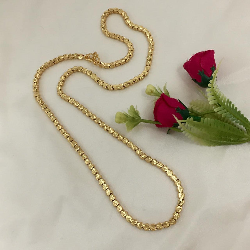 A gold chain necklace displayed on a flat surface.