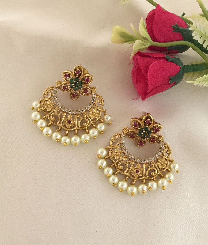 Gold and pearl earrings with floral design and intricate detailing.