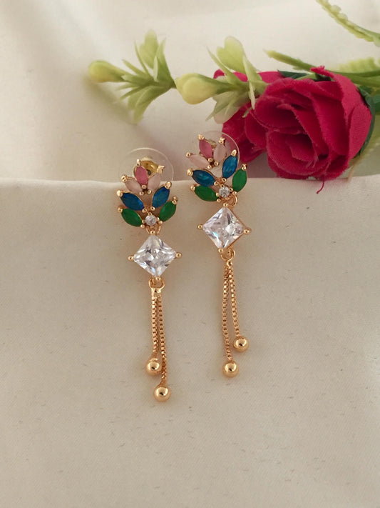 Gold earrings with colorful gemstones and dangling chains.