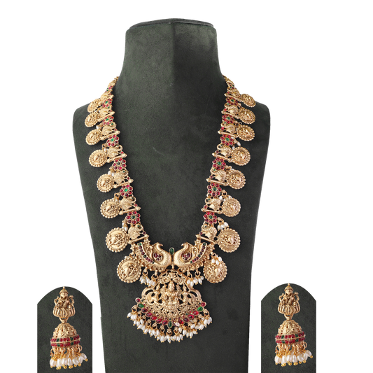 Gold necklace with intricate designs and matching earrings displayed on a black stand.