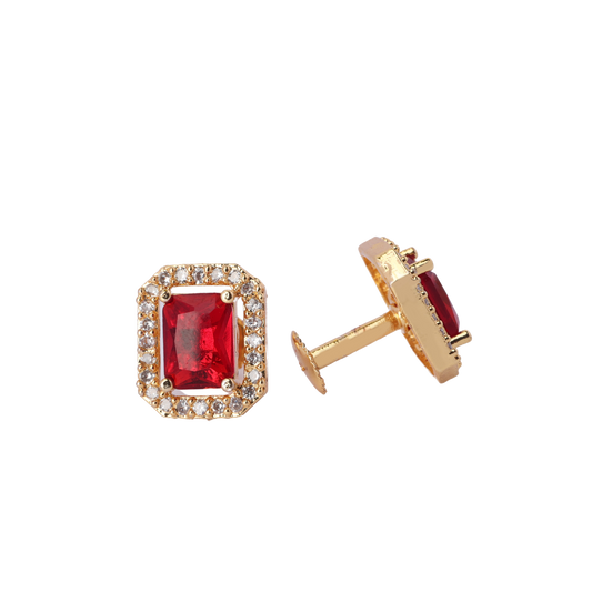 A pair of gold stud earrings featuring rectangular red gemstones surrounded by small clear stones.