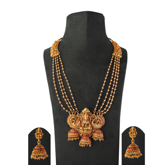 Gold necklace with intricate design featuring a central deity figure, accompanied by matching gold jhumka earrings.