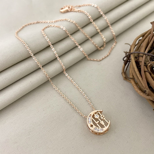 A gold necklace with a pendant featuring the word "Love" and small embedded crystals.