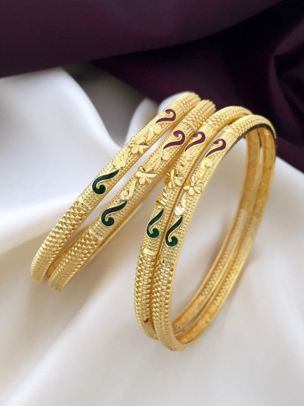 Three intricately designed gold bangles with green and maroon enamel detailing.