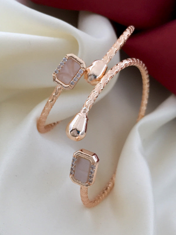 Two rose gold bracelets with rectangular gemstone settings and textured bands.