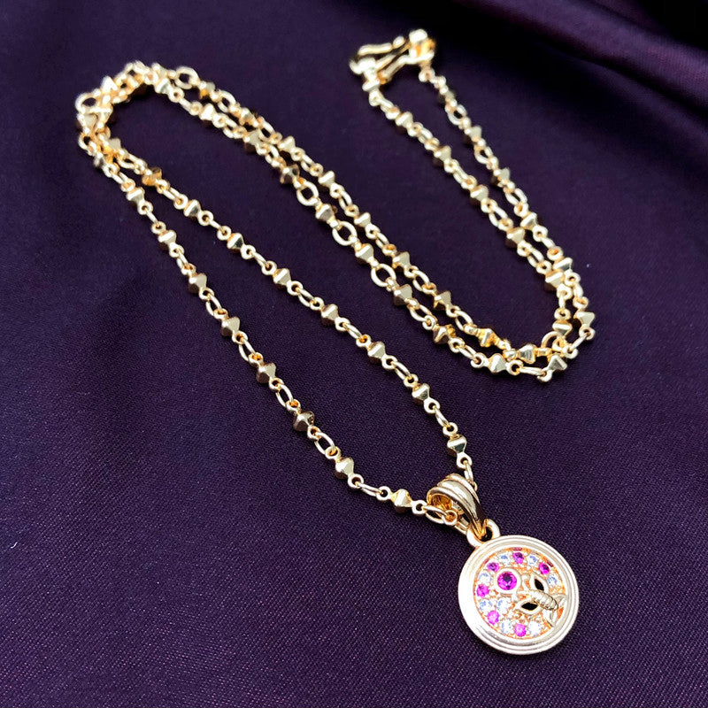 A gold chain necklace with a round pendant featuring pink and white gemstones.