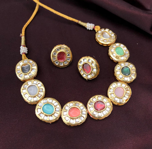 A gold necklace and matching earrings with circular, multicolored gemstone settings.