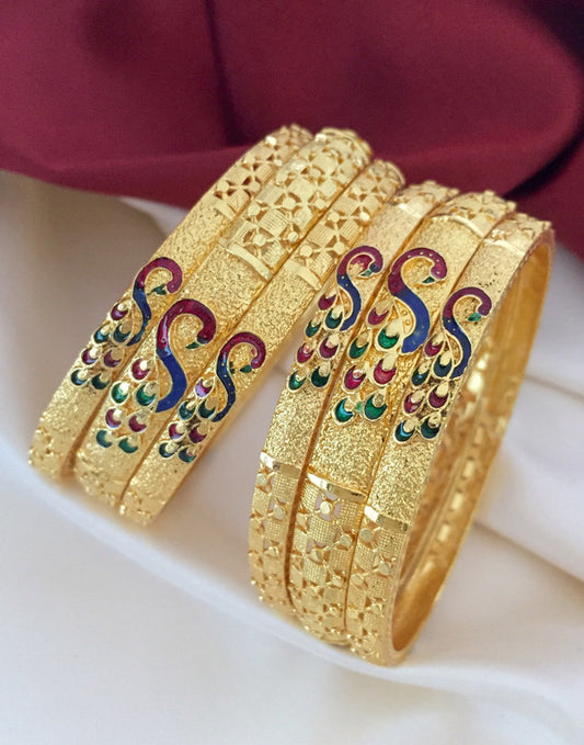 Gold bangles with intricate designs and colorful peacock motifs.