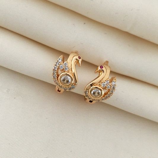 Gold swan-shaped earrings adorned with small diamonds and a central larger diamond.