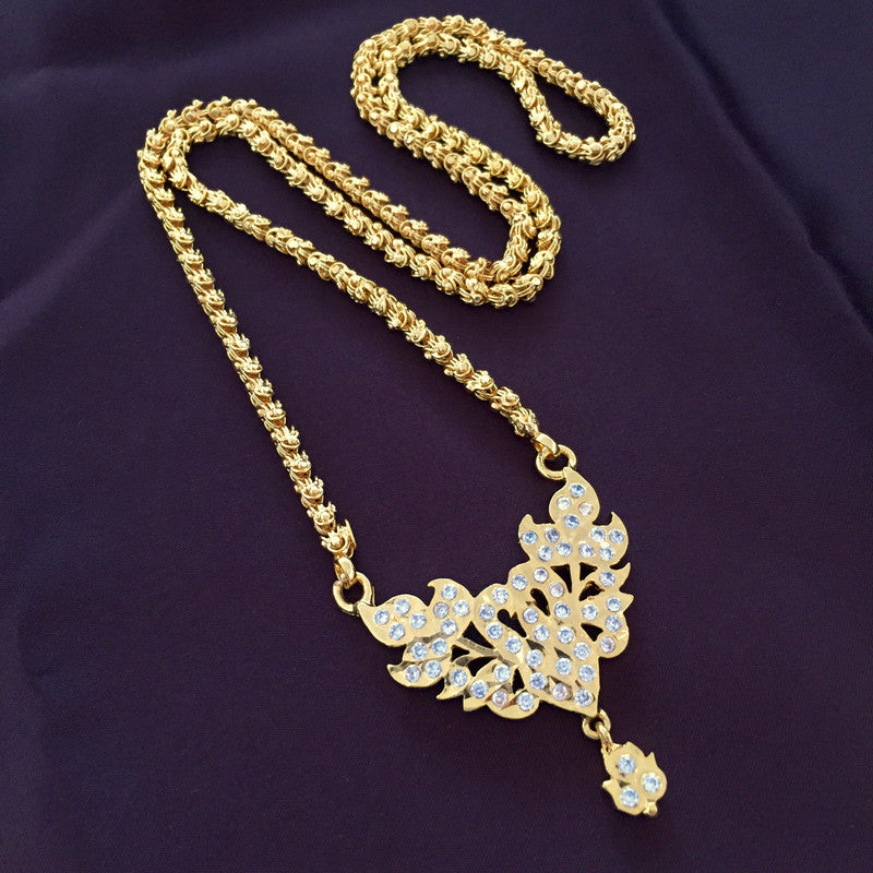 A gold necklace with an intricate pendant design featuring leaf-like patterns and embedded with small, sparkling stones. The chain has a twisted rope design.