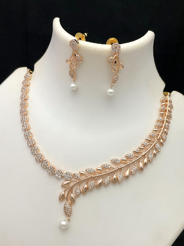 Gold necklace and earring set with leaf design and pearl accents.