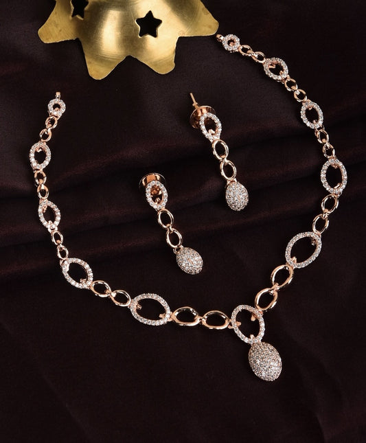 A gold necklace and earring set with oval links and encrusted with small diamonds.