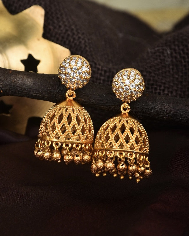 Gold jhumka earrings with intricate lattice design and studded tops.