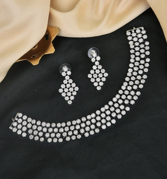 A diamond-studded choker necklace with matching diamond-studded earrings.