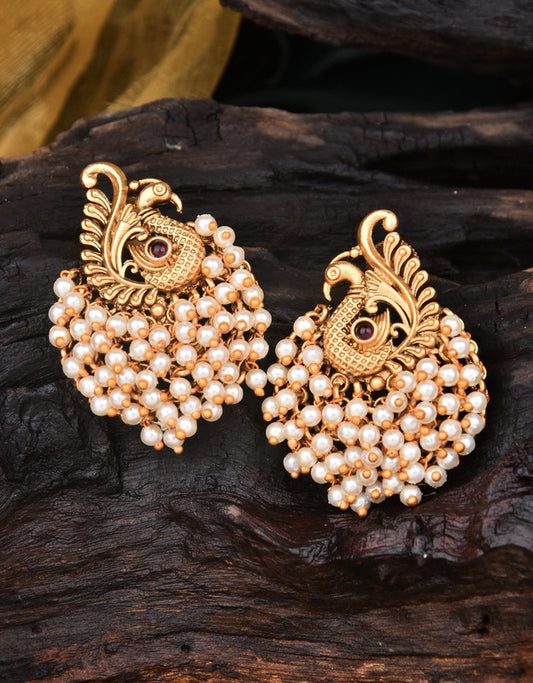 Gold-toned peacock-shaped earrings adorned with clusters of small white pearls.