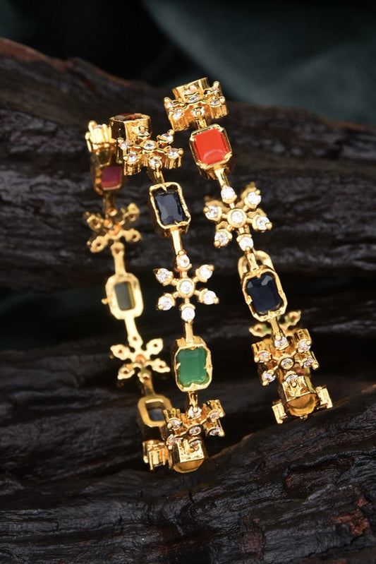 Two gold bracelets adorned with various colored gemstones and small diamonds.