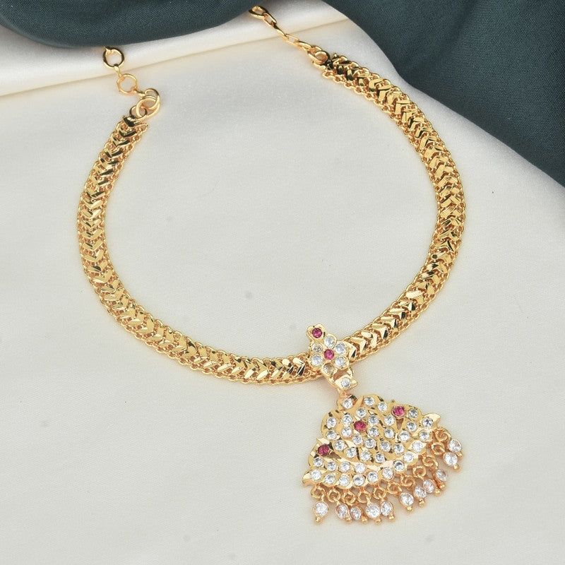 A gold necklace with a decorative pendant featuring multiple small gemstones.