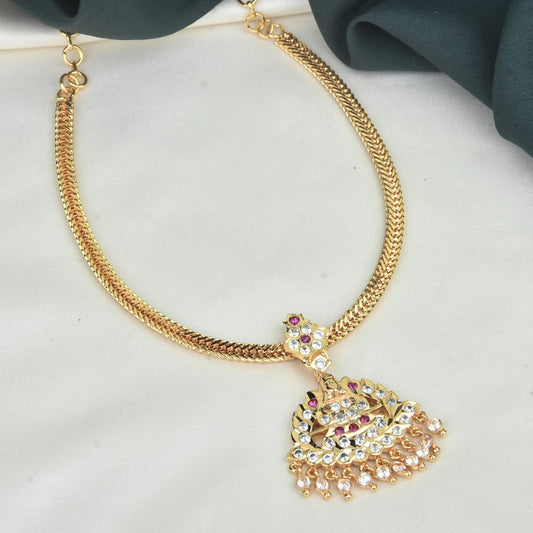 A gold necklace with a peacock-shaped pendant adorned with colorful gemstones.