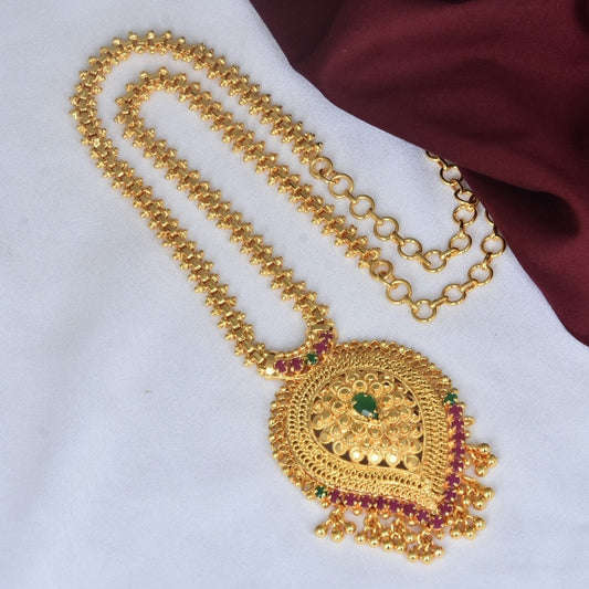 Gold necklace with an intricate pendant design featuring green and red gemstones.