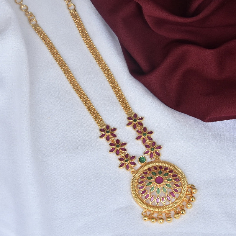 A gold necklace with a circular pendant featuring intricate floral designs in red and green, adorned with small gold beads at the bottom. The chain has additional floral motifs in red and green.