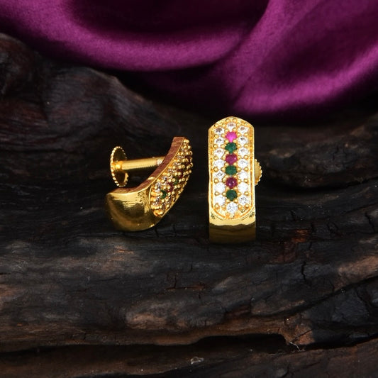 Gold earrings with multicolored gemstones arranged in a vertical line, displayed on a dark textured surface.