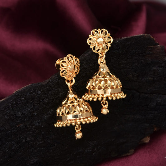 Gold jhumka earrings with intricate floral design and dangling beads.