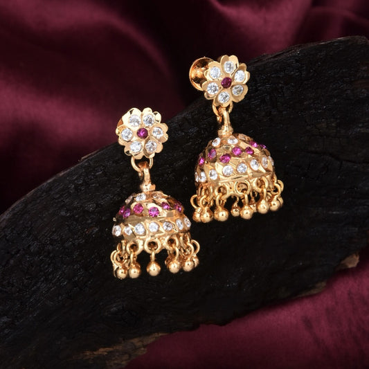 Gold jhumka earrings with floral design, adorned with white and pink stones.