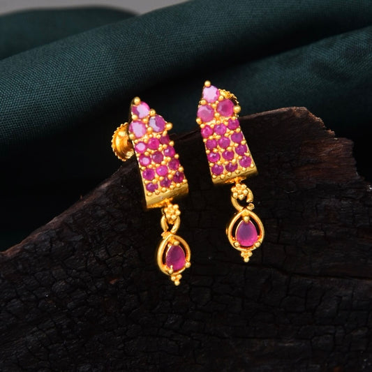 Gold and pink gemstone earrings with intricate design.