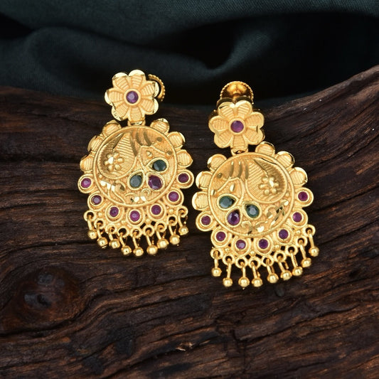 Gold earrings with intricate floral and peacock designs, adorned with colorful gemstones.